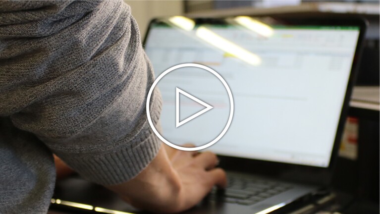 A person types on a computer