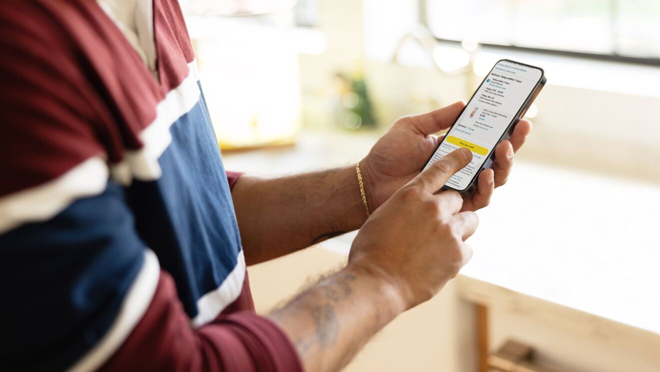 Person checking smartphone app with detailed information on screen