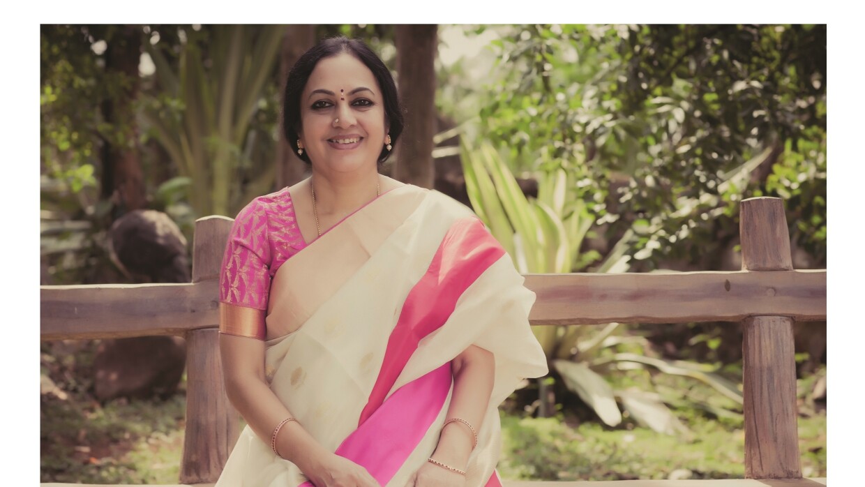 Author Bhanumathi sits on a bench as she poses for a pic