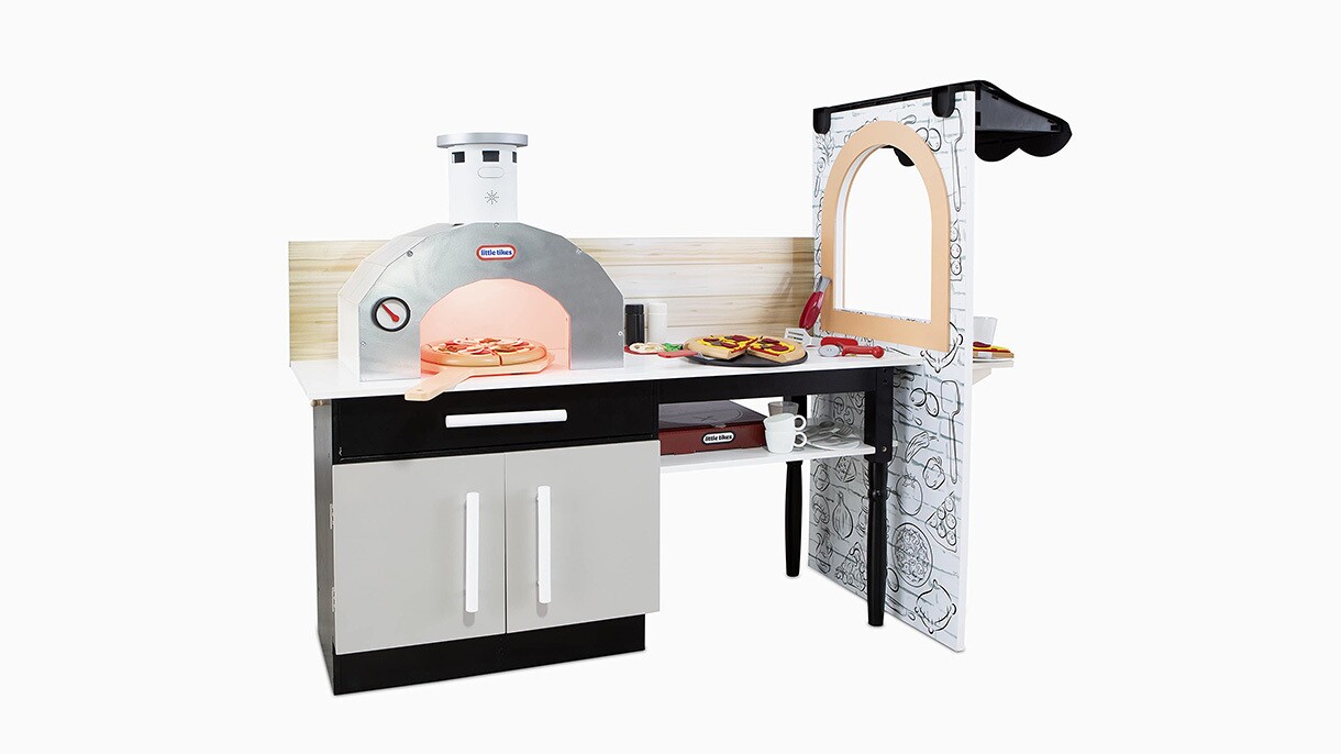 An image of a toy kitchen set with a pizza oven and a serving window and counter space.