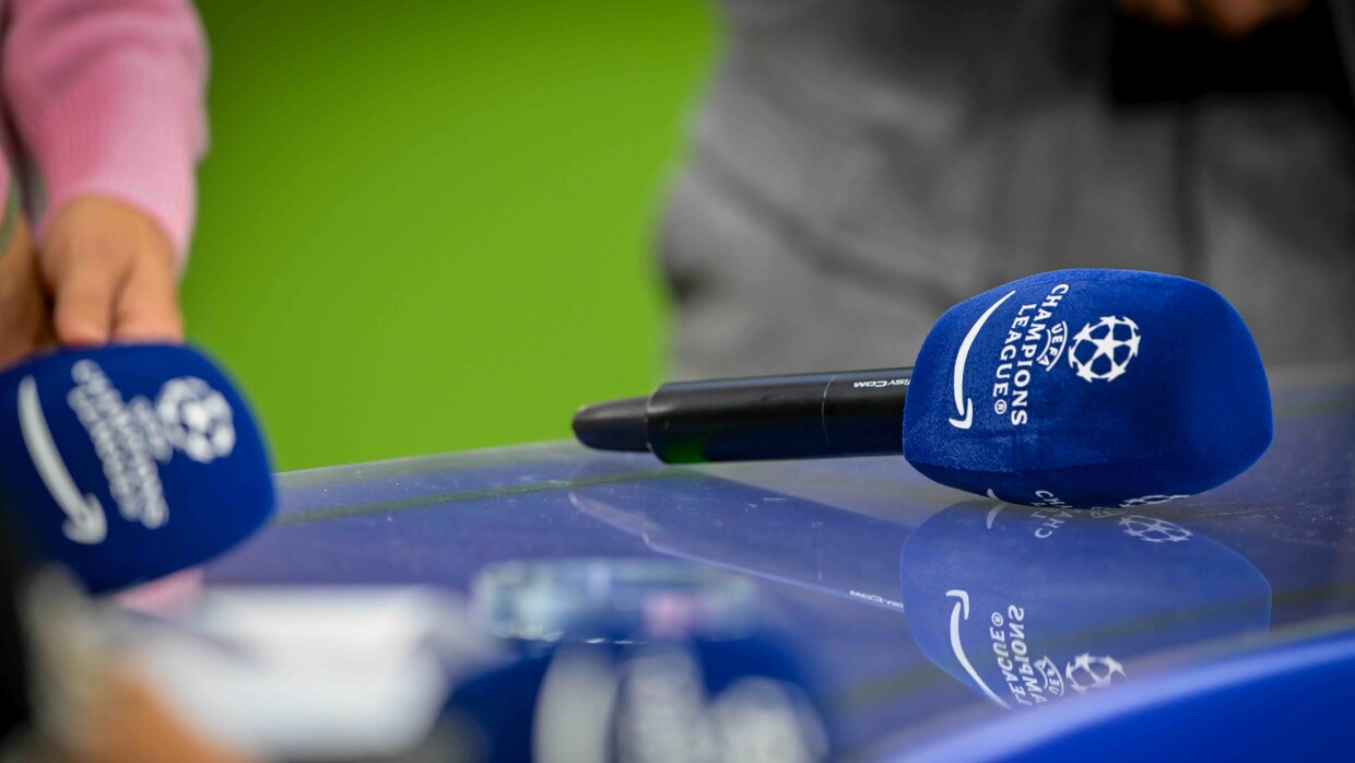 Blue UEFA Champions League microphones on reflective surface