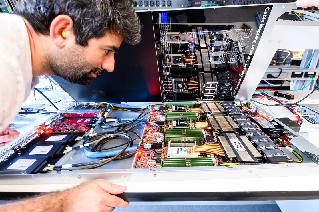 A man looks at a board of computer chips. 