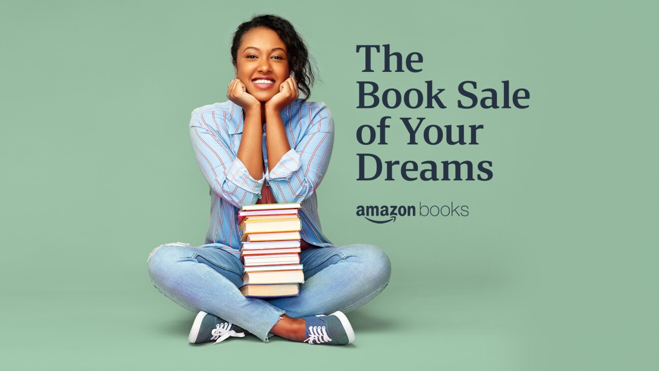 An image of a woman sitting with a stack of books and text that reads The Book Sale of Your Dreams, Amazon Books.