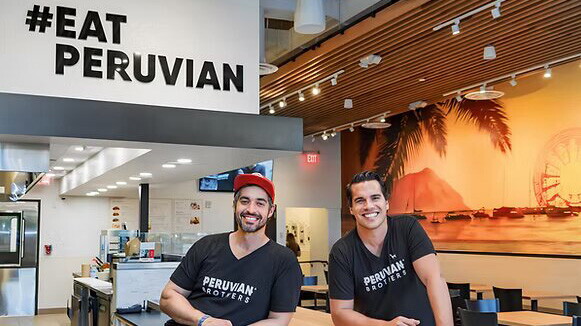 #eatperuvian sin behind two men posing
