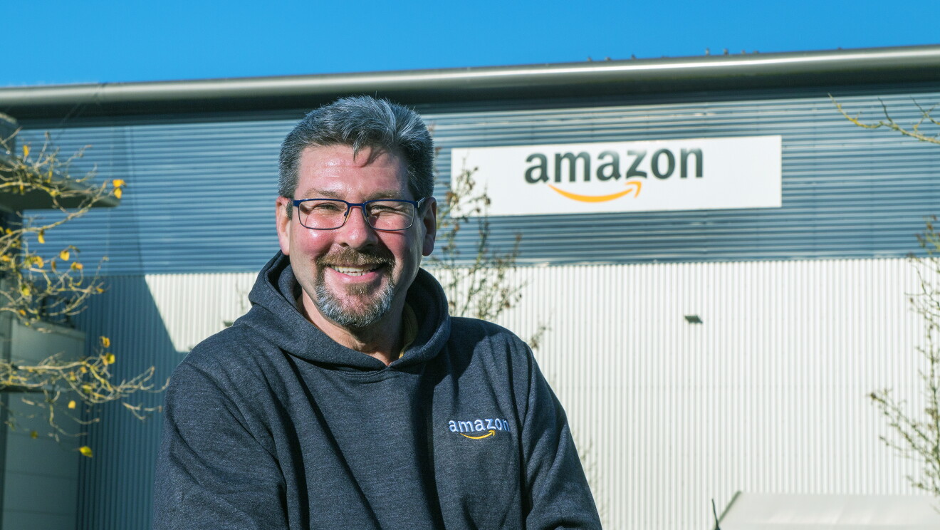Andrew Norman, FC Associate, Hemel Hempstead standing in front of a Fulfilment Centre.