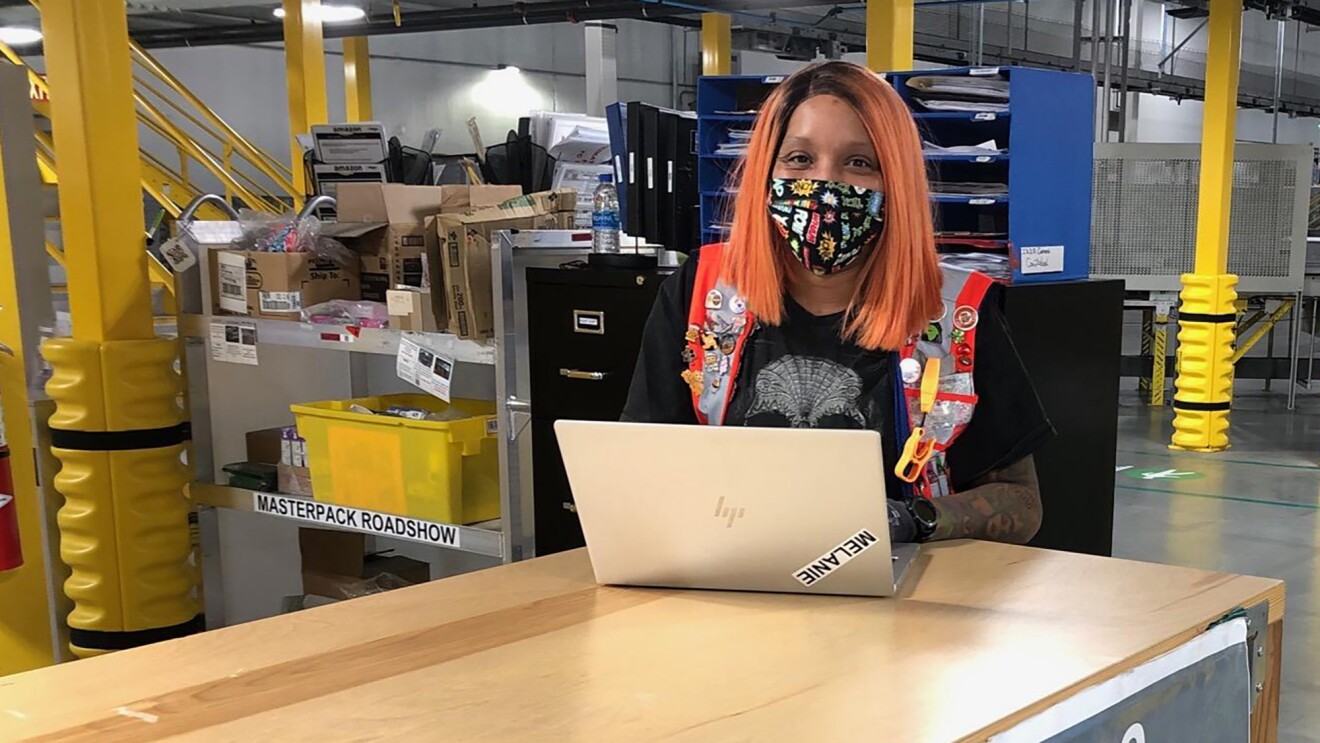 Woman Amazon associate wearing a mask while working