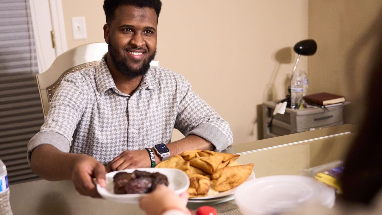 An image of Abdiaziz, an Amazon area manager, eating dinner at home.