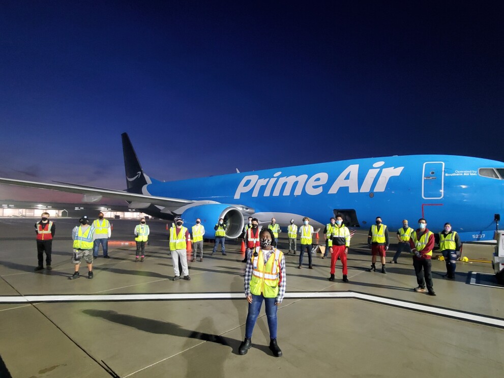 Amazon employees who work on the middle mile, posing for the camera at work