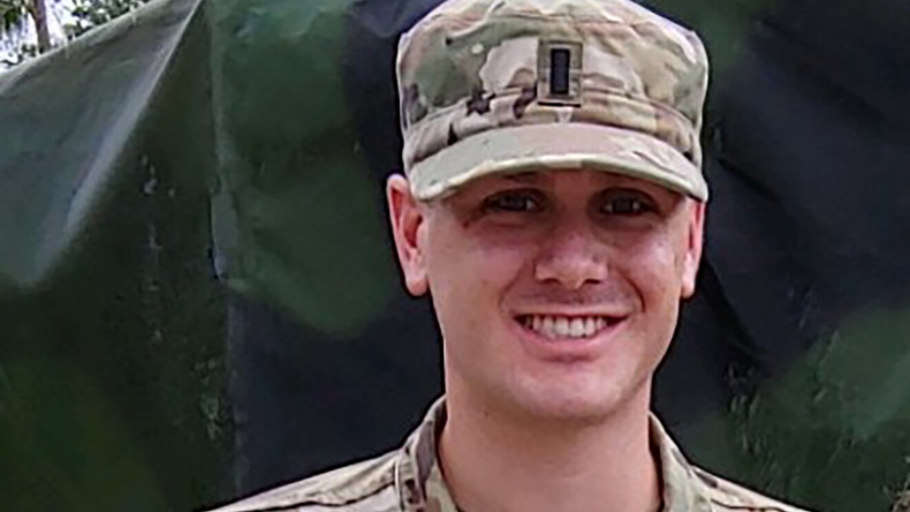 A man wearing a National Guard uniform in a military setting