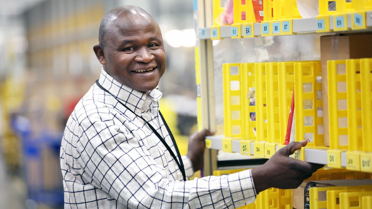 Francis Mensah, fulfilment centre employee at Amazon in Hemel Hempstead, pictured at work