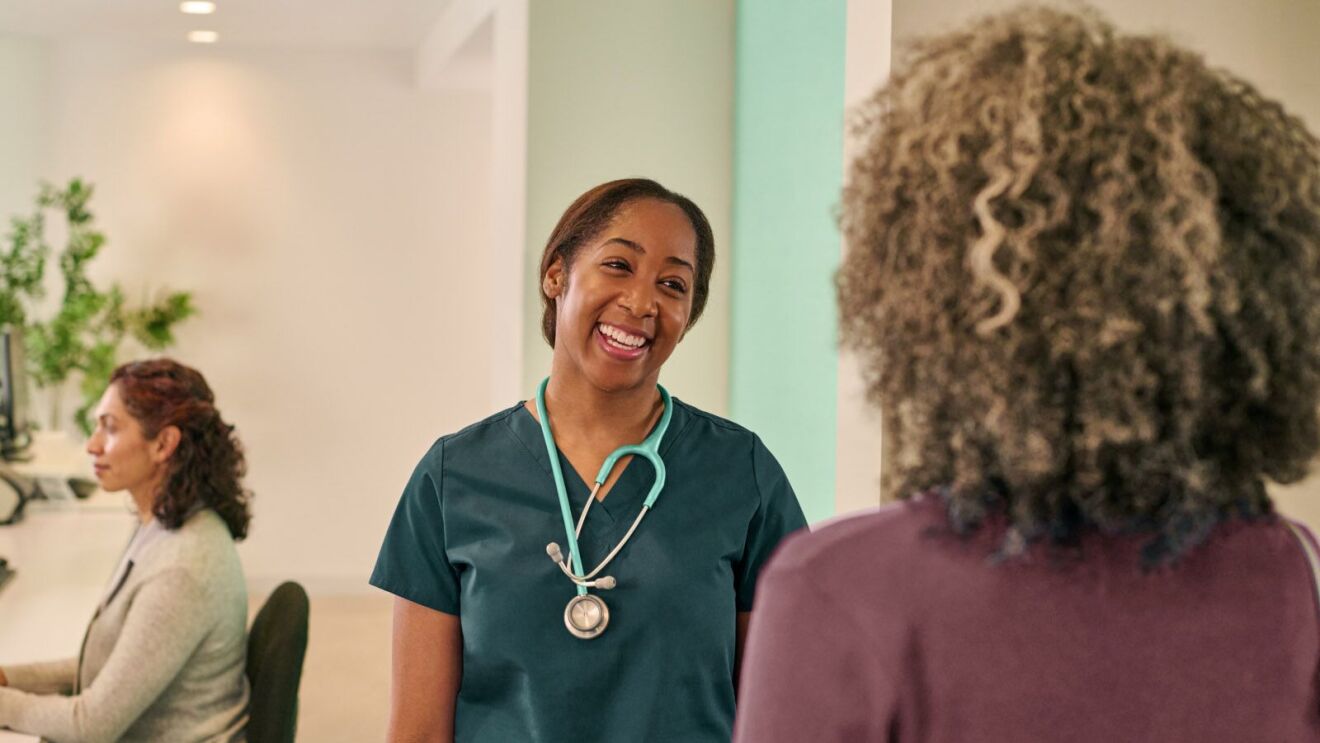 Medical professional engaging warmly with patient in clinic setting