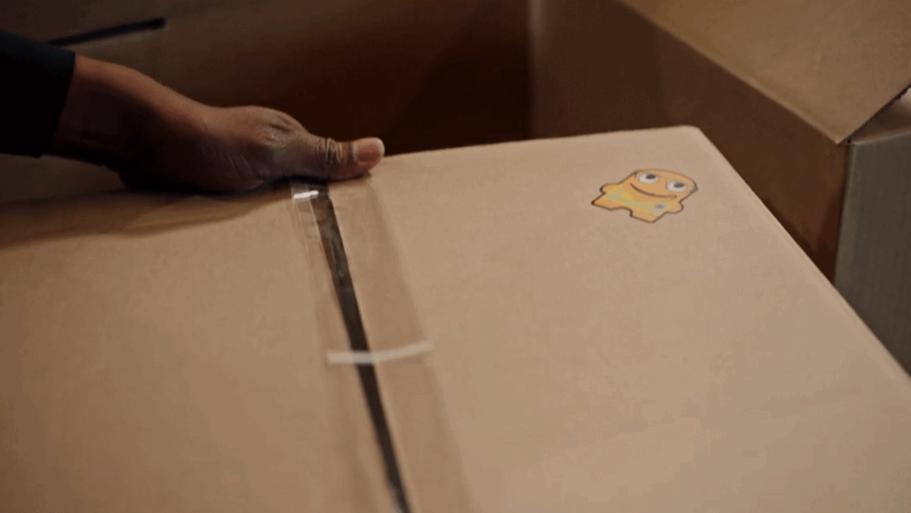 A close-up image of an Amazon box with a sticker on it.