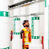 Worker in safety vest amid industrial water pipe labels
