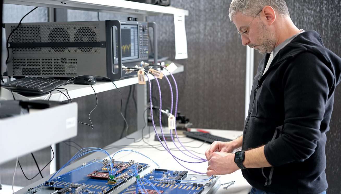 A photo of a lab technician testing AWS Trainium2.