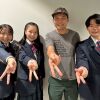 Japanese YouTuber Ghib Ojisan and Japanese high school students giving the peace sign in the AWS Singapore office.