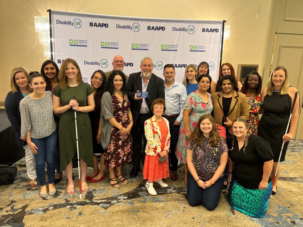 The Amazon team smiles and poses for a group picture at the award ceremony.