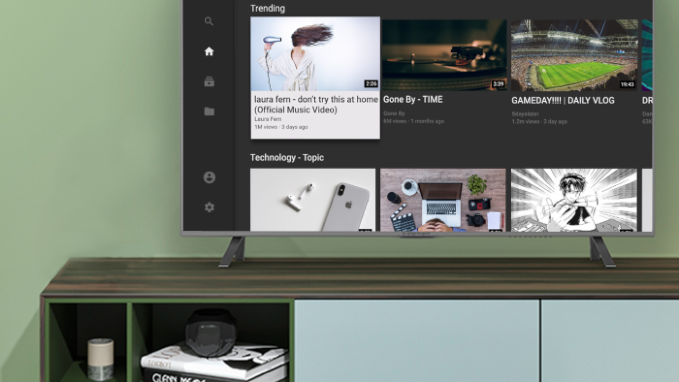 A television sits on a console table, with the television screen displaying the YouTube experience on Fire TV.