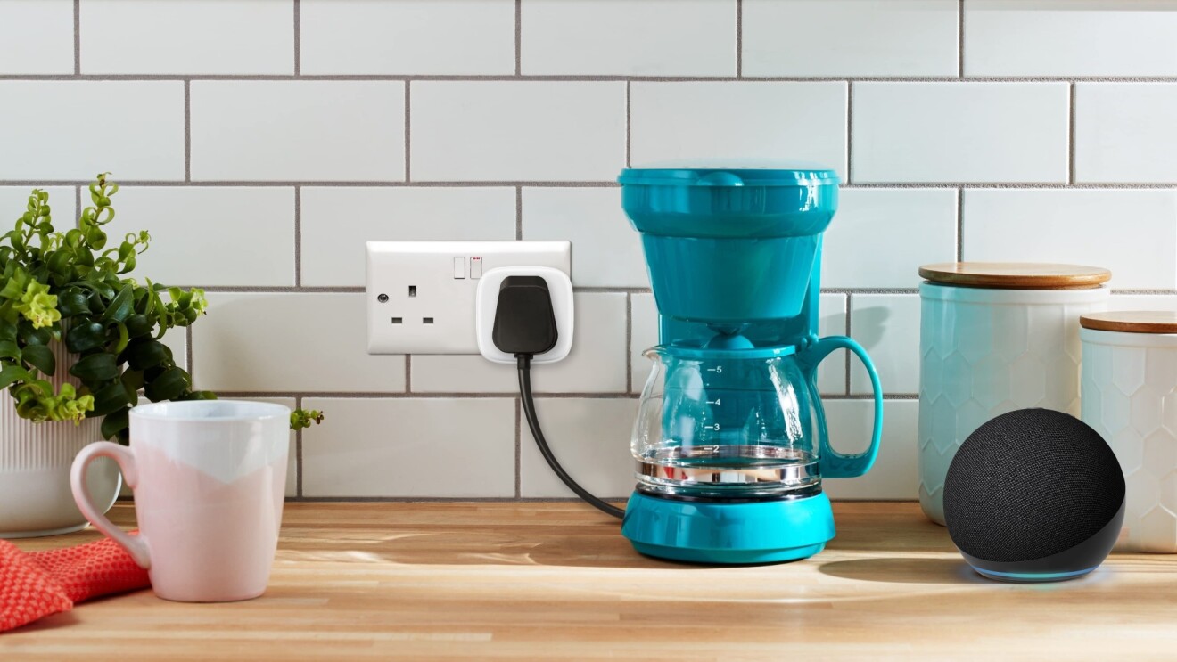Modern kitchen counter with teal coffee maker and Echo Dot smart speaker

