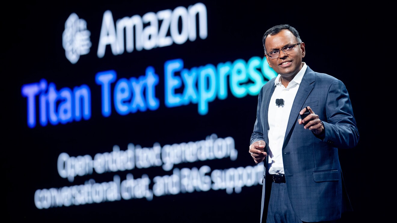 A photo of AWS Vice President of Data and AI Swami Sivasubramanian on stage at AWS re:Invent 2023, presenting about Amazon Titan.