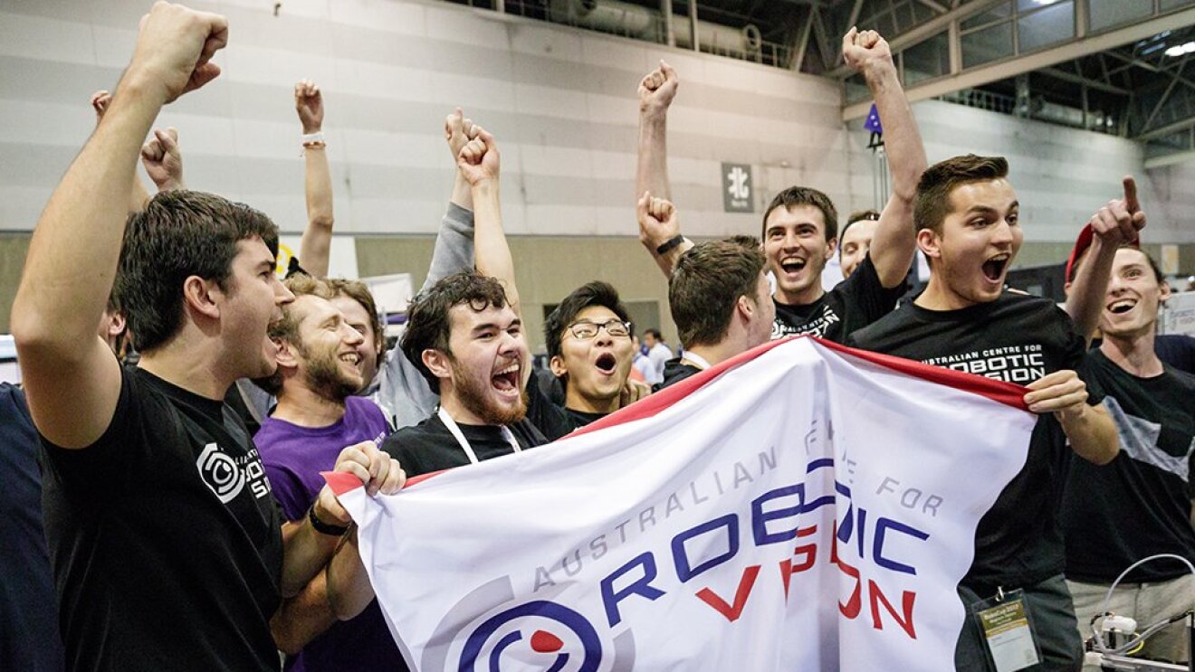 A group of Australian students cheer after winning the Amazon Robotics Challenge.