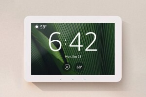 An image of an Echo Hub mounted on a wall showing the home screen.