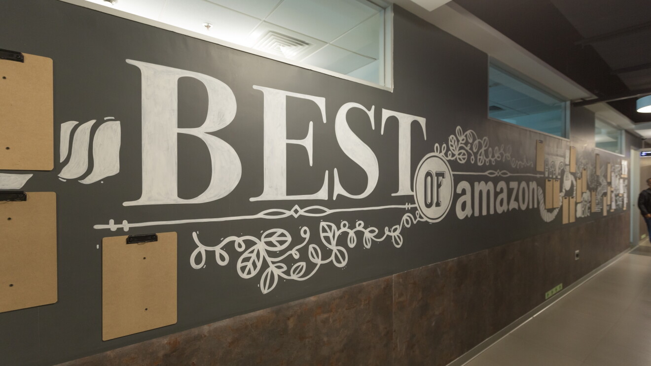 The walls in an Amazon building that is painted with the words "best of Amazon"