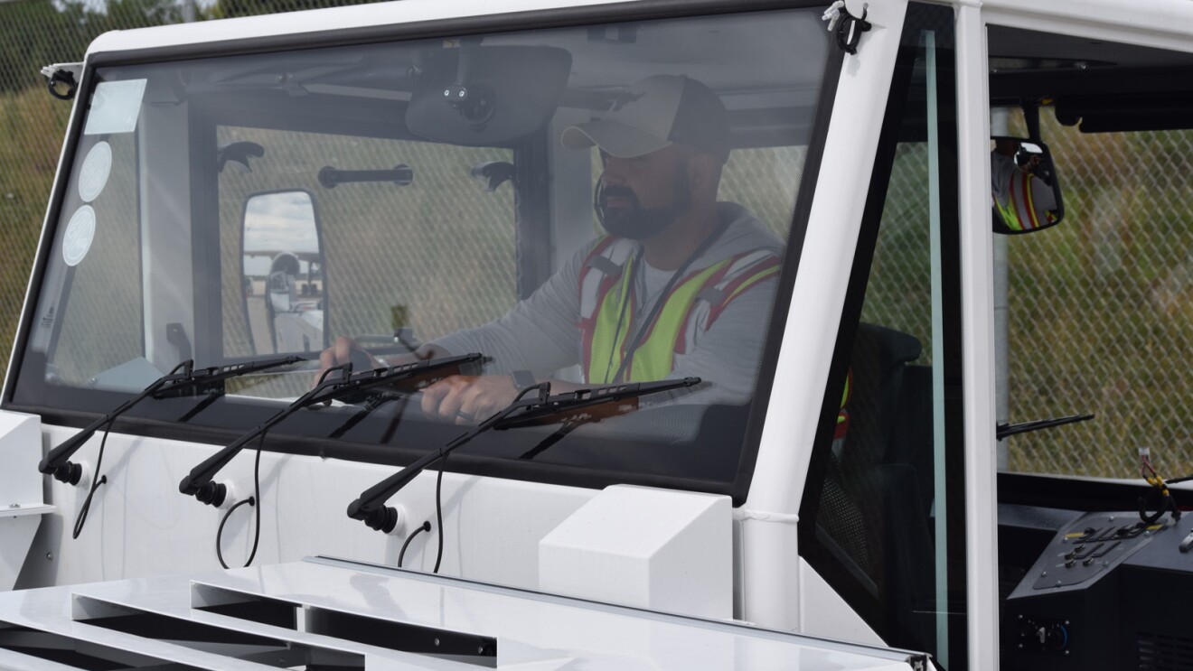 An image of a Kentucky Air hub employee working with the equipment in the loading zone.