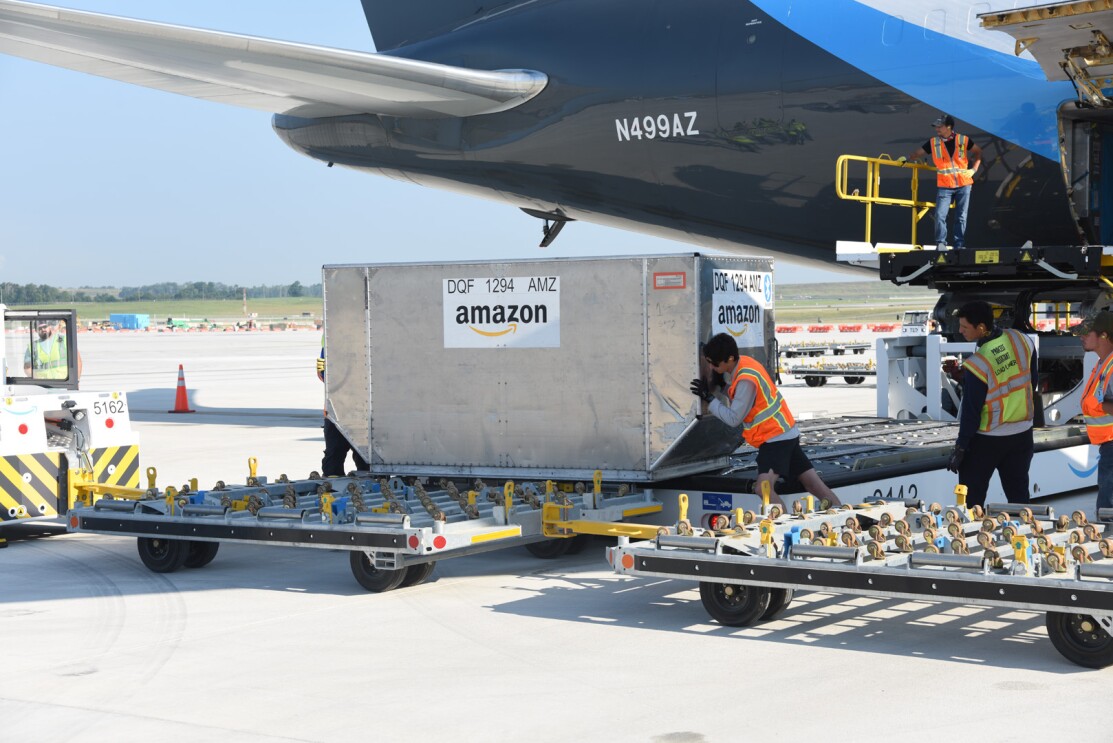 An image of  a large metal container on a trailer in front of the Prime Air plane.