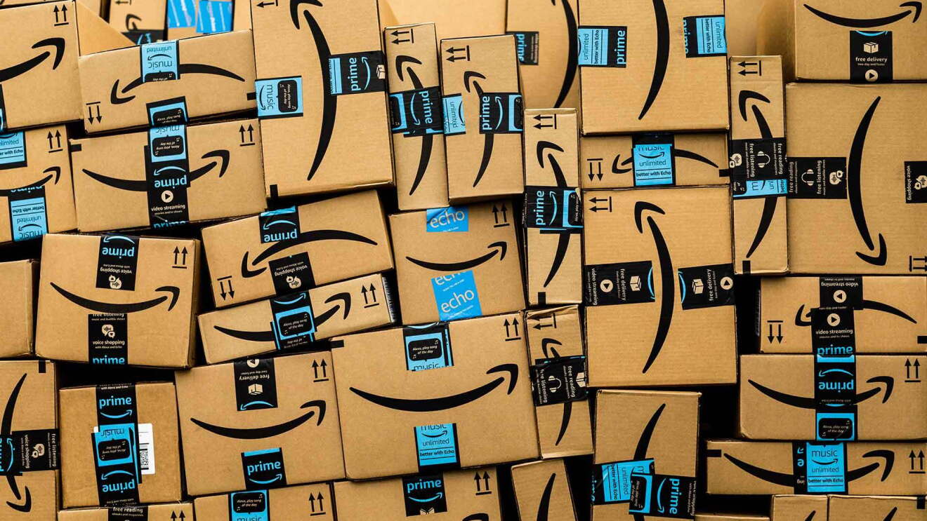 Dozens of Amazon boxes taped and stacked, ready to be shipped to customers. 