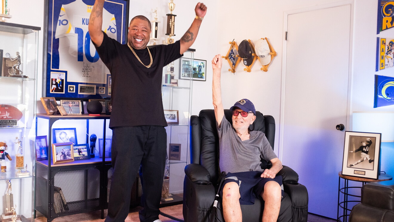 An image of TV personality Xzibit and Lewis Lazarus looking at a frame in Lazarus' new fan cave. 