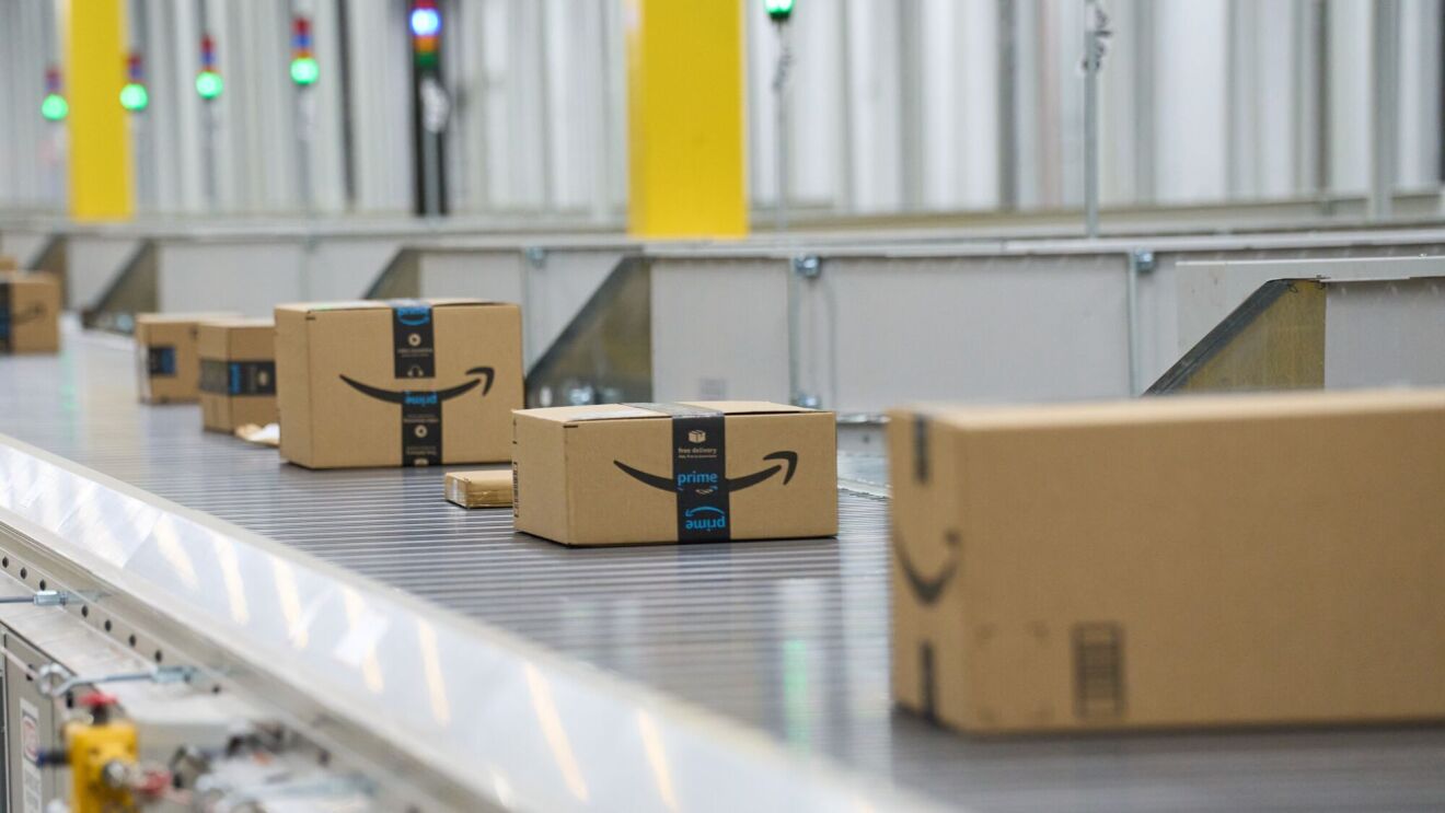 An image of Amazon boxes traveling in a fulfillment center.