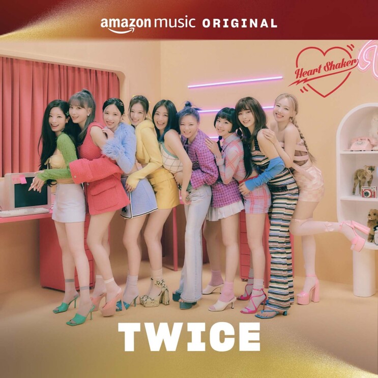 An image of the album cover for TWICE's holiday song. There are multiple women standing behind eachover and holding each other while smiling for a photo in a pastel-colored room.