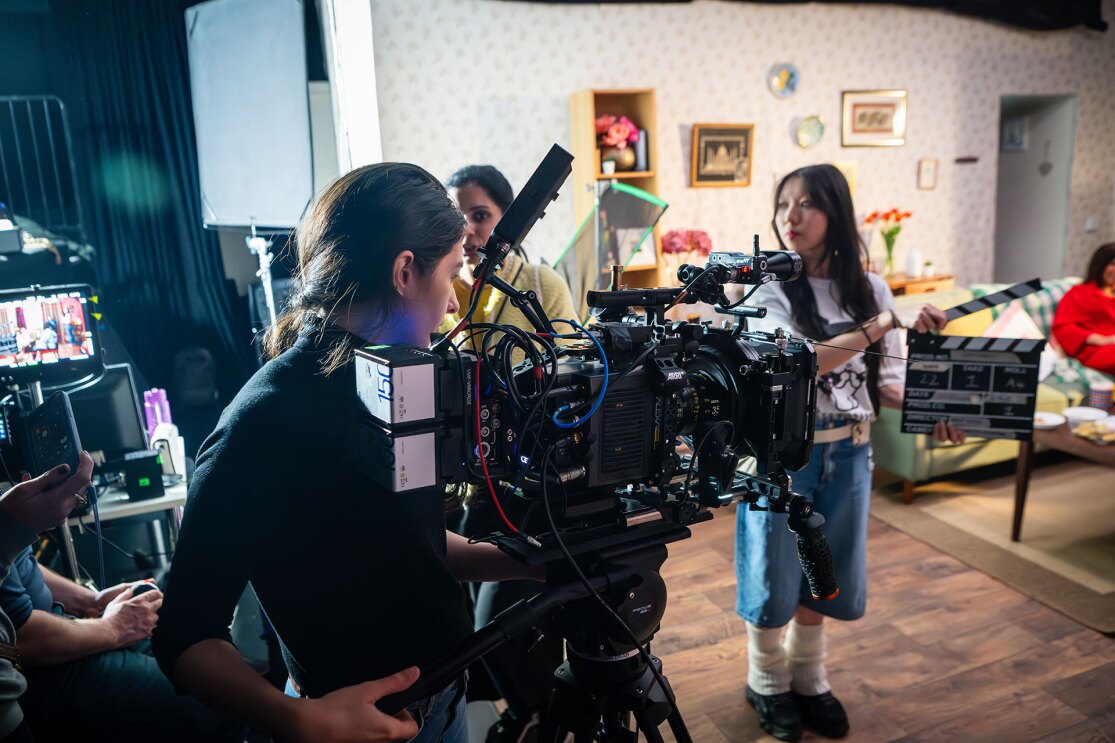 Behind-the-scenes of movie production in decorated living room