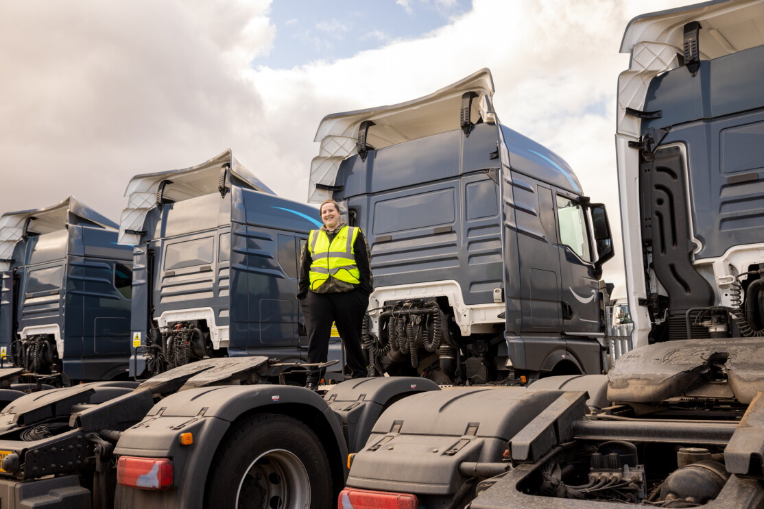Photograph of Sam standing on delivery trucks
