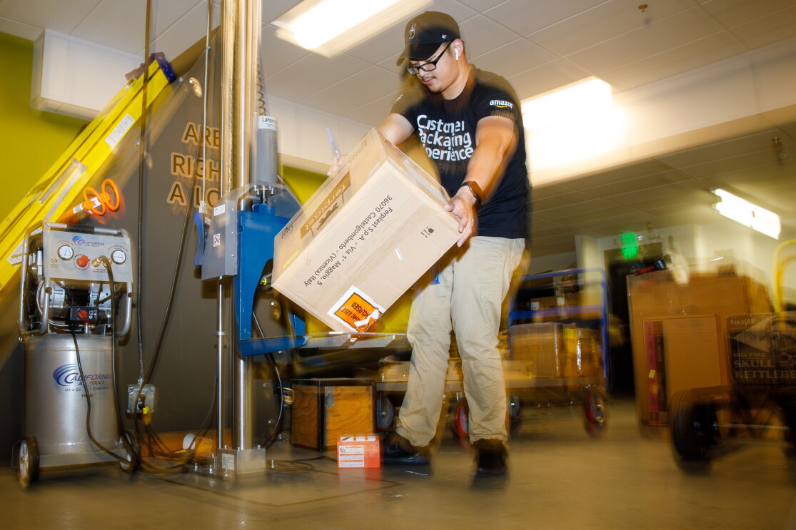 A package falls while a man stands behind it.