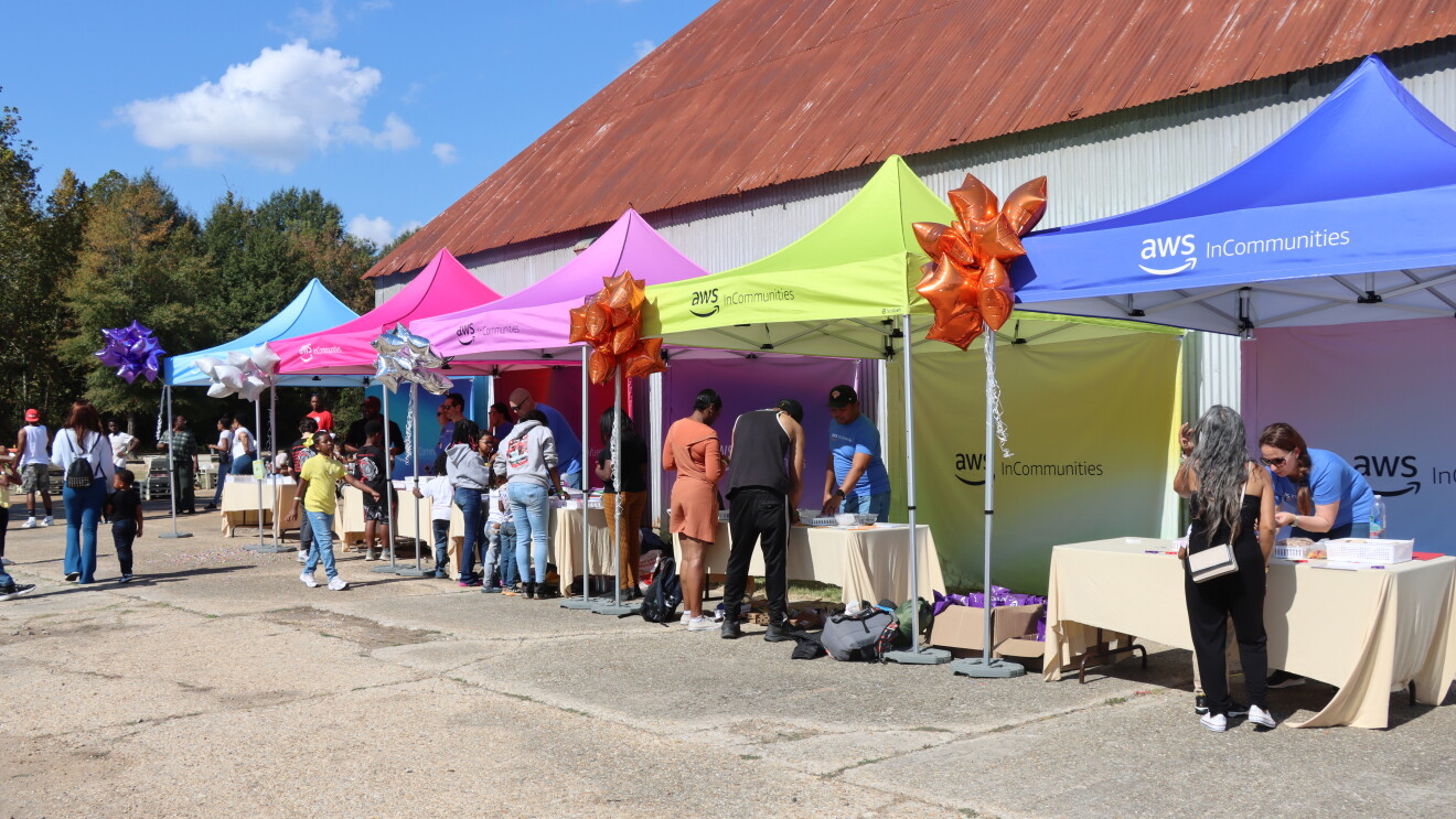 Bean Path's 6th Annual Block Party: Colorful AWS InCommunities event tents with attendees