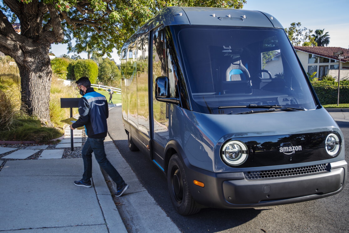 An Amazon delivery driver parks at the end of a driveway to delivery a package.