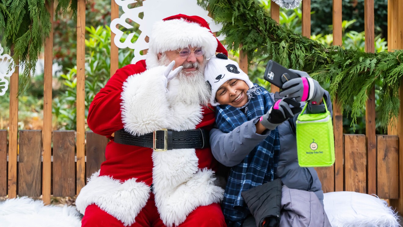 Sanata taking a selfie with a young girl