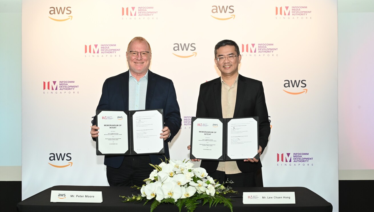 AWS and IMDA representatives holding up signed MOI