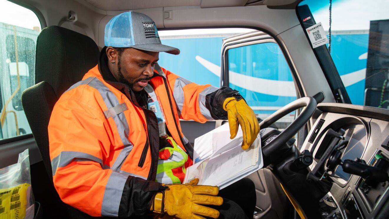 portraits and environmental photos of abel tuyisenge, a transportation operations management associate at amazon, as he drives and inspects trucks