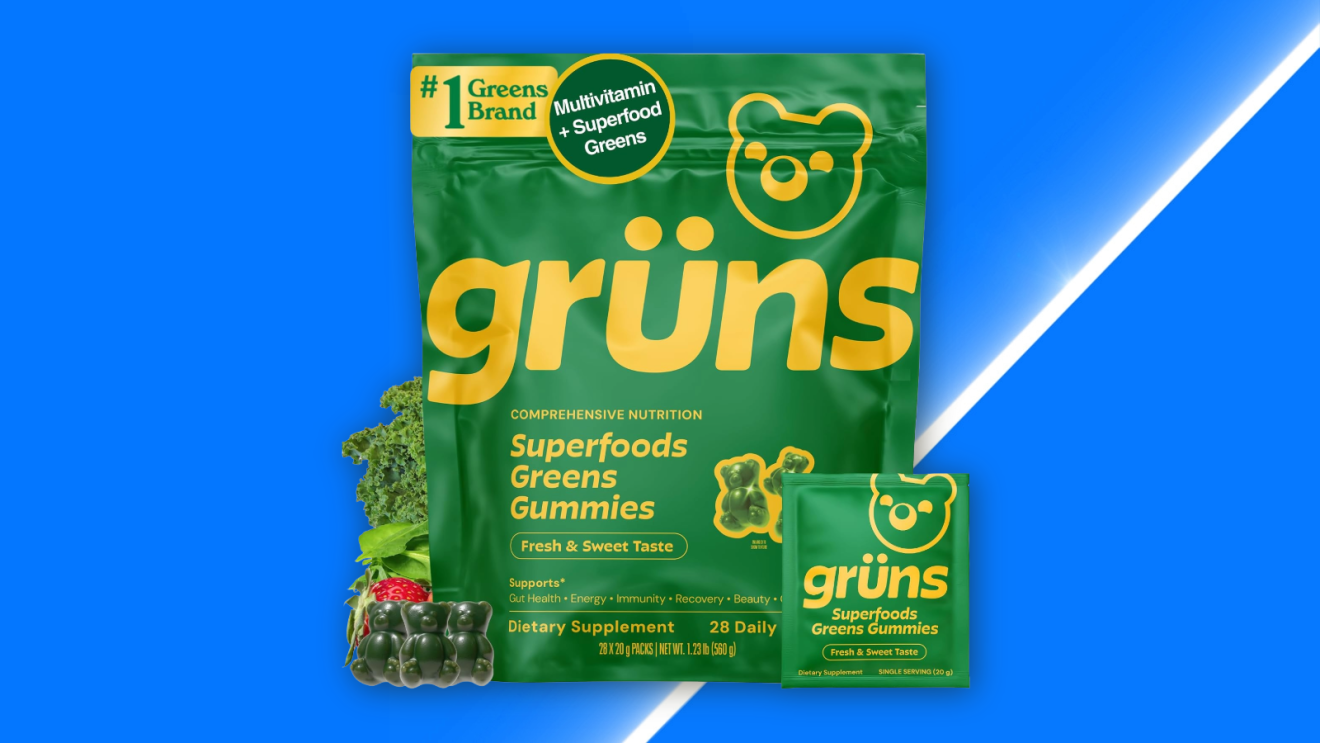 Grüns Superfoods Greens Gummies pouch with bear logo, surrounded by kale, strawberries, and blueberries for Amazon Prime Big Deal Days 2026