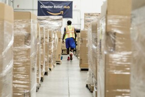 An amazon employee packs boxes of relief items to ship to Florida