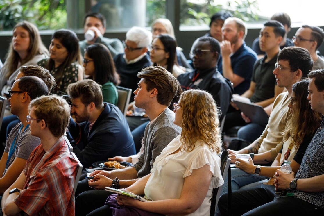 Dozens of individuals are seated, as they listen to the fireside chat at Seattle University.