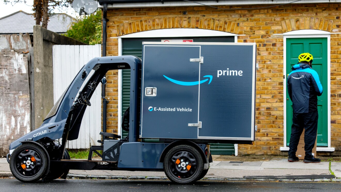 Amazon Prime e-assisted delivery bike parked outside brick building