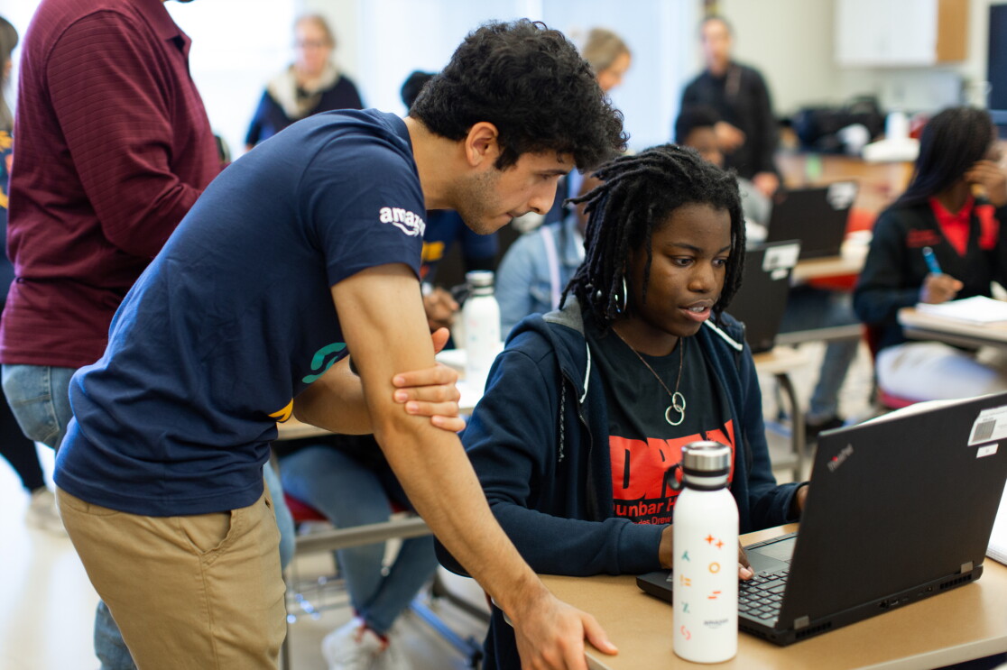 Amazon employee volunteers work on coding projects with students at Dunbar High School in Washington, DC to celebrate Amazon Future Engineer's 2,000 high schools milestone.