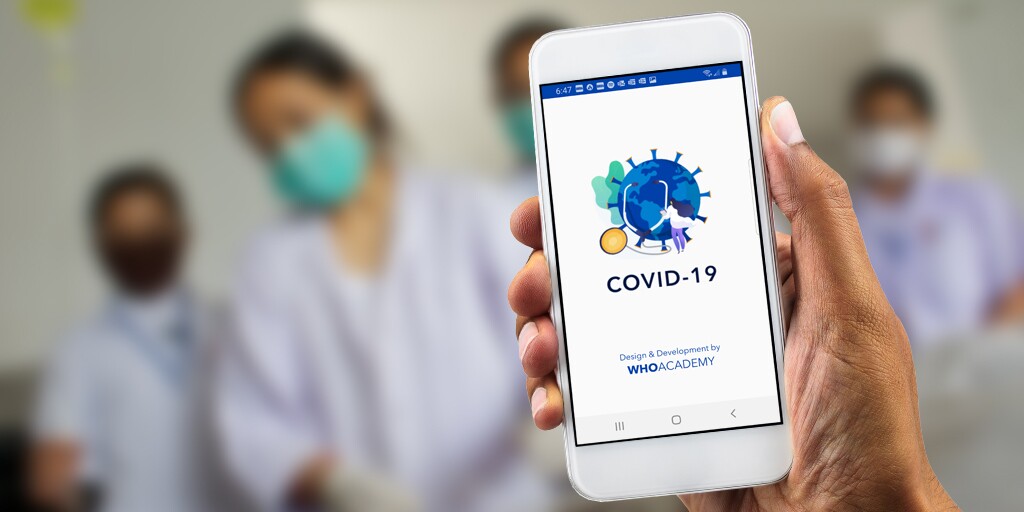 World Health Organization Academy app on a mobile phone, held in a patient's hand with four medical personnel blurred out in the background.