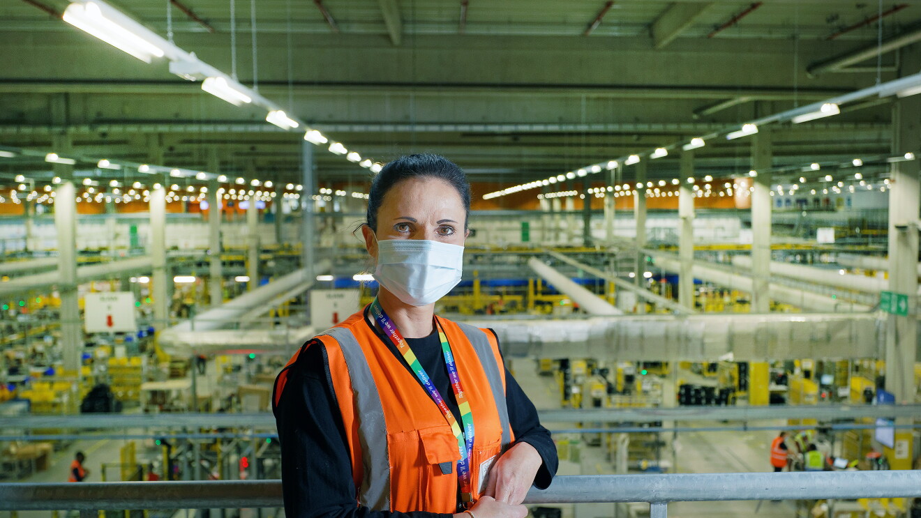 Sarah Jones, WHS Coordinator at Amazon's fulfilment centre in Swansea, stood on a mezzanine with the shop-floor in the background