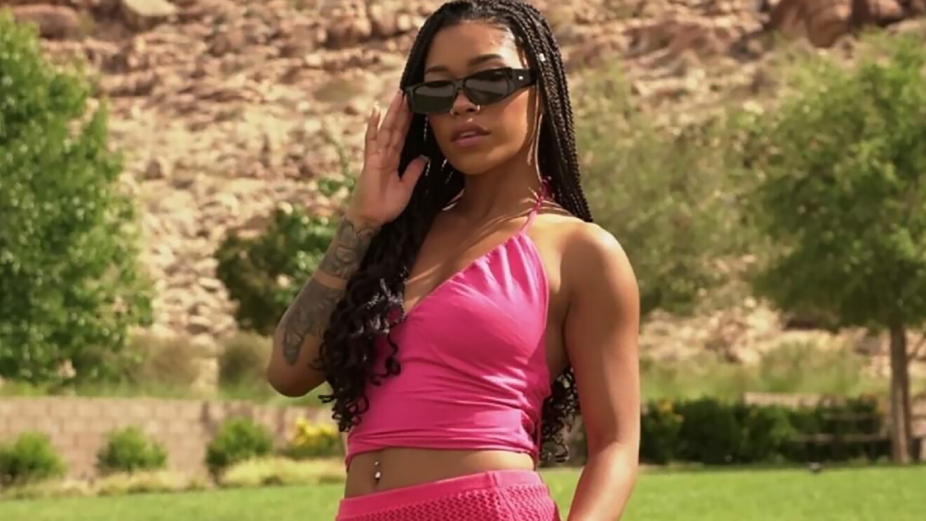 Prime Day 2023 live blog best deals: woman wearing sunglasses and a pink set in a desert park.