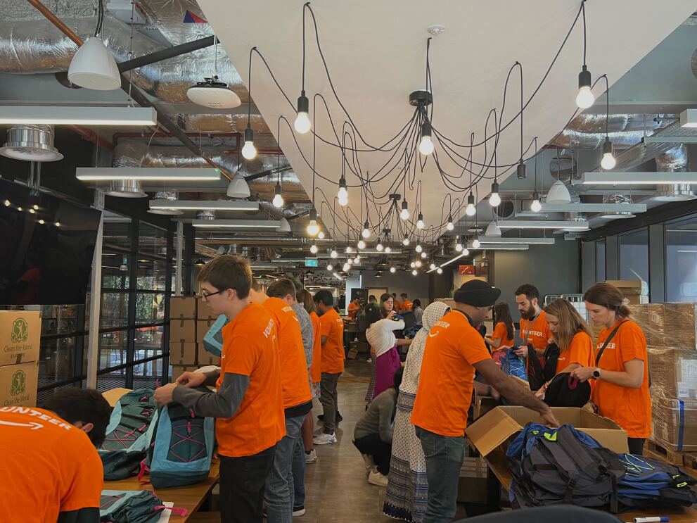 Amazon colleagues pack back-to-school backpacks for the Global Month of Volunteering