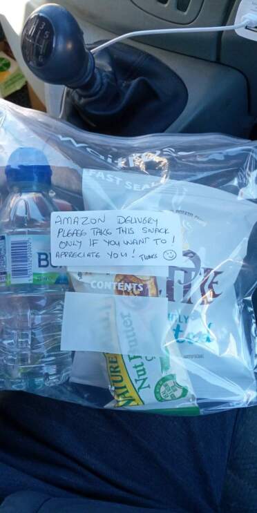 A bag containing gifts for an Amazon Delivery driver. On the bag there is a thank you note.